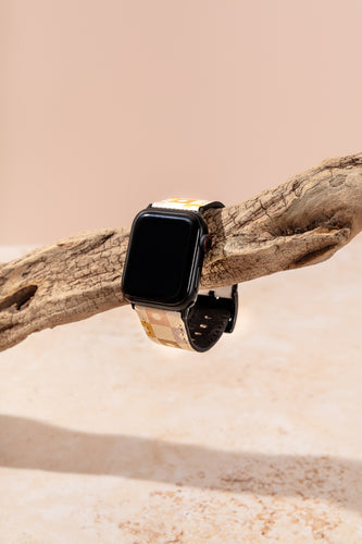 Plant based vegan leather Apple Watch band holding on a tree branch.