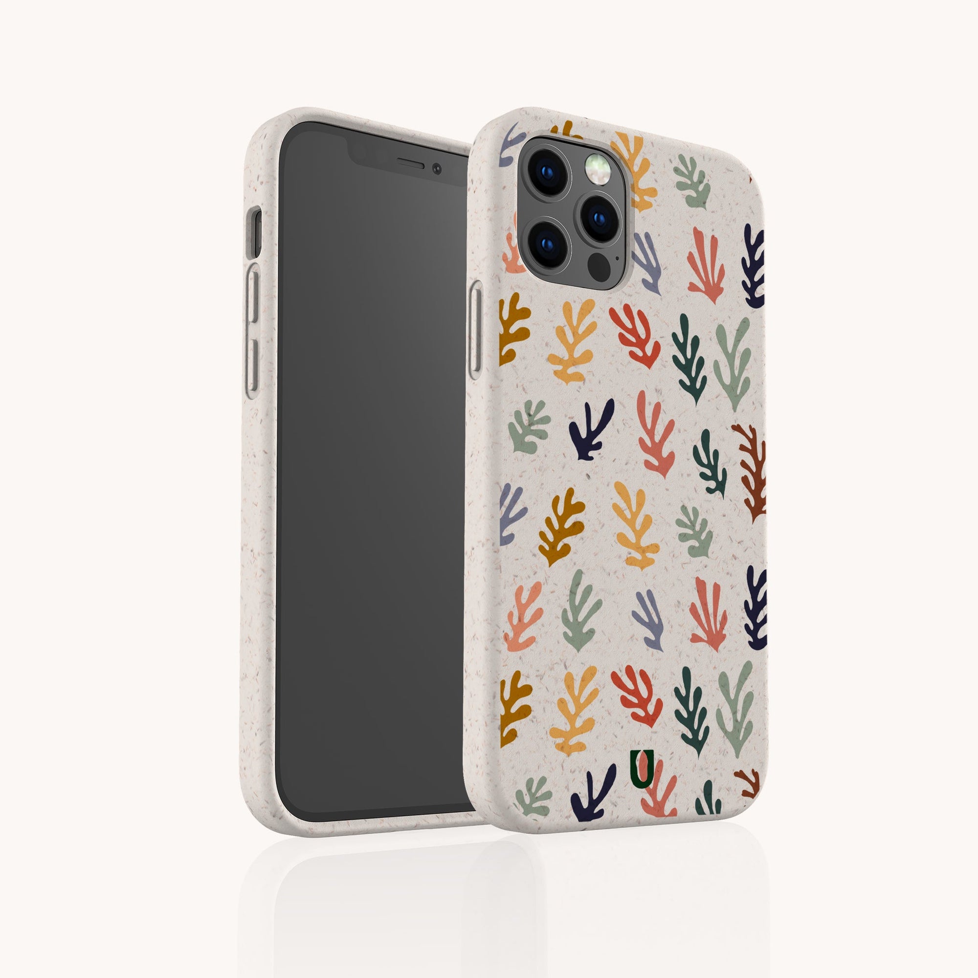 A smartphone in the Algae Eco-Friendly Phone Case, beige and made from biodegradable materials, features a vibrant abstract coral pattern in red, yellow, blue, green, and black. Shown angled to display both sides.