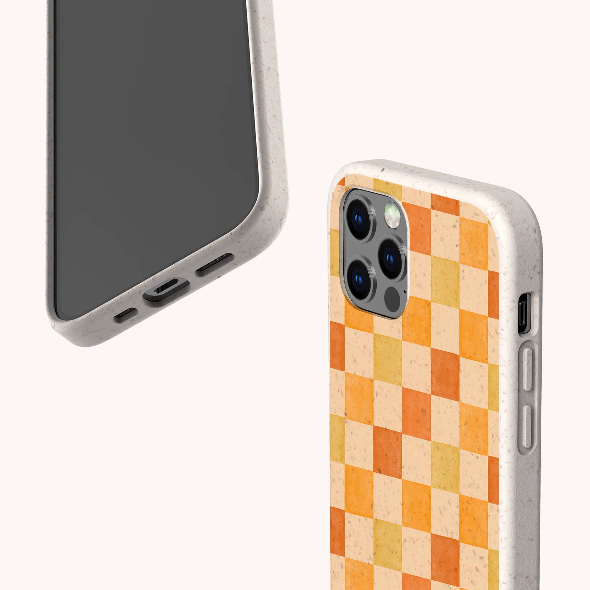 Two smartphones in Brown and Orange Checker Eco-Friendly Phone Cases—one displays the screen and charging port, while the other shows an orange-yellow checkerboard patterned triple camera case. Compatible with iPhone and Samsung Galaxy.