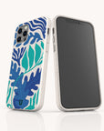 Two smartphones in biodegradable, eco-friendly phone cases—one featuring the bold blue and green tropical leaf design of the Sea Bed Eco-Friendly Phone Case, evoking an ocean-inspired look. One phone displays the vibrant Sea Bed design on its back, while the other shows a blank black screen.