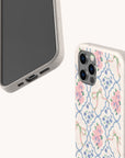 Two smartphones in beige cases; one features a plain screen, while the other displays the Pink Ribbons Eco-Friendly Biodegradable Phone Case, showcasing a floral pattern with pink and purple flowers and green ribbons on a white background. Both cases offer an eco-friendly design that blends style with sustainability.