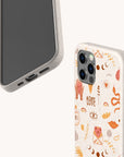 Two smartphones in beige cases; one showcases the Love Potion Eco-Friendly Phone Case adorned with a playful heart pattern featuring hearts, eyes, leaves, hands, and the word LOVE in red and orange hues—perfect for sustainable gifting—while the other case remains plain. The background is off-white.