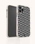 Two smartphones in Black Flower Checker Eco-Friendly Phone Cases are shown against a plain background. One phone displays the screen, while the other shows the back, highlighting the repeating black-and-white floral checker design of these eco-friendly cases.