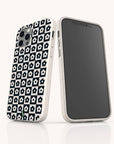 Two smartphones in white cases: one features the Black Flower Checker Eco-Friendly Phone Case, showcasing its black and white floral checker design, while the other displays a blank, dark screen facing forward.