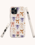 Introducing the Bows Eco-Friendly Biodegradable Phone Case, a plant-based phone case adorned with a playful pattern of pink, purple, and orange bows on a cream background. This sustainable case is showcased from multiple angles—including the front, back, and sides—to highlight its thoughtful design and eco-friendly features.