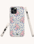 The Pink and Blue Coquette Flowers Eco-Friendly Biodegradable Phone Case features a pastel floral pattern with blue ribbons and green leaves on a light background, shown from the back, side, and bottom angles.