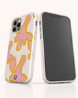 Two smartphones with white cases featuring abstract pink and yellow bunny shapes. One phone shows the front screen, while the other displays the colorful case design. Both are standing upright on a white surface, showcasing the Pink Abstract Flowers Eco-Friendly Phone Case—an ideal stylish choice for eco-conscious users.