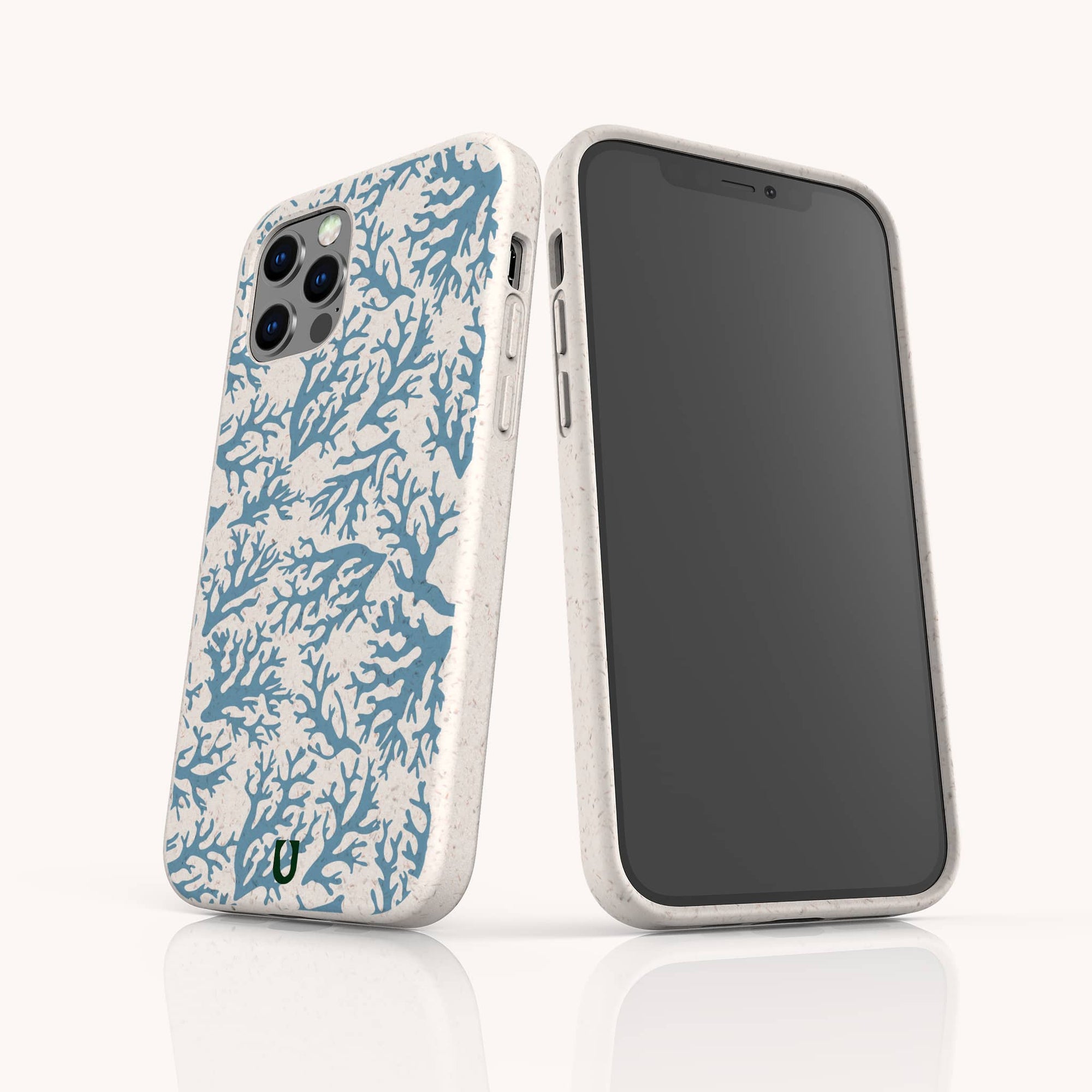 Two smartphones in white Blue Coral Eco-Friendly Phone Cases with marine-inspired blue coral reef patterns. One shows the screen; the other displays the case’s patterned back, camera cutout, and subtle speckled texture.