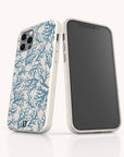 Two smartphones in white Blue Coral Eco-Friendly Phone Cases with marine-inspired blue coral reef patterns. One shows the screen; the other displays the case’s patterned back, camera cutout, and subtle speckled texture.