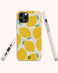 The Lemons Eco-Friendly Phone Case features a citrus pattern with yellow lemons and green leaves on a cream background, shown from the back and sides to highlight the design, button placements, and compostable materials.