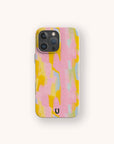 The Mango Sorbet Eco-Friendly Phone Case features an abstract pattern in pink, yellow, blue, and white brushstrokes with a small horseshoe-shaped logo at the bottom center. Compatible with iPhone and Samsung Galaxy models.