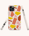 A Paper Scraps Eco-Friendly Biodegradable Phone Case with a terrazzo pattern in pink, yellow, orange, and red shapes on a white background, displayed from the back, side, and front angles.