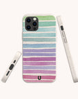 The Winter Rainbow Eco-Friendly Phone Case features pastel horizontal stripes in green, blue, purple, and pink hues. Displayed from the back, side, and bottom angles against a light background, this sustainable case offers a playful yet stylish look while being made from eco-friendly materials for a conscious accessory choice.