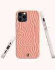 Three views of the Pink Distorted Lines Eco-Friendly Phone Case shown on a smartphone in pink, featuring wavy light pink lines and a small horseshoe logo at the bottom. The side views display the phone’s buttons and charging port, emphasizing its sustainable design.
