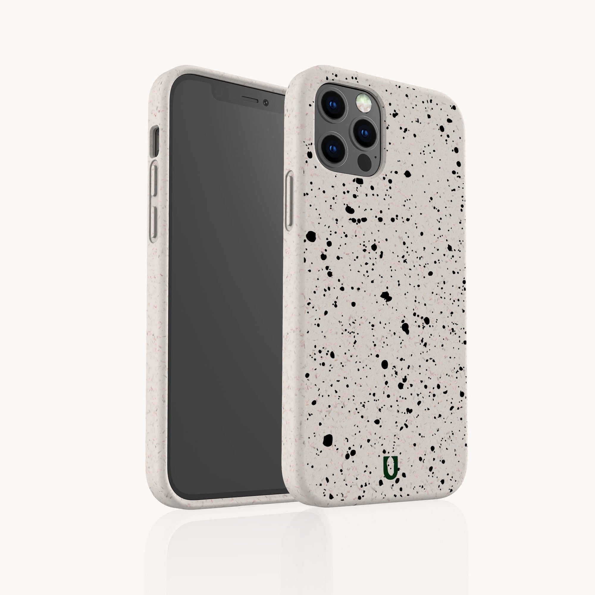 The Black Splatter Eco-Friendly Phone Case in beige features a minimal design with black splatter patterns, triple rear camera cutouts, and a small green "U" logo on the back. Shown from both front and back views.