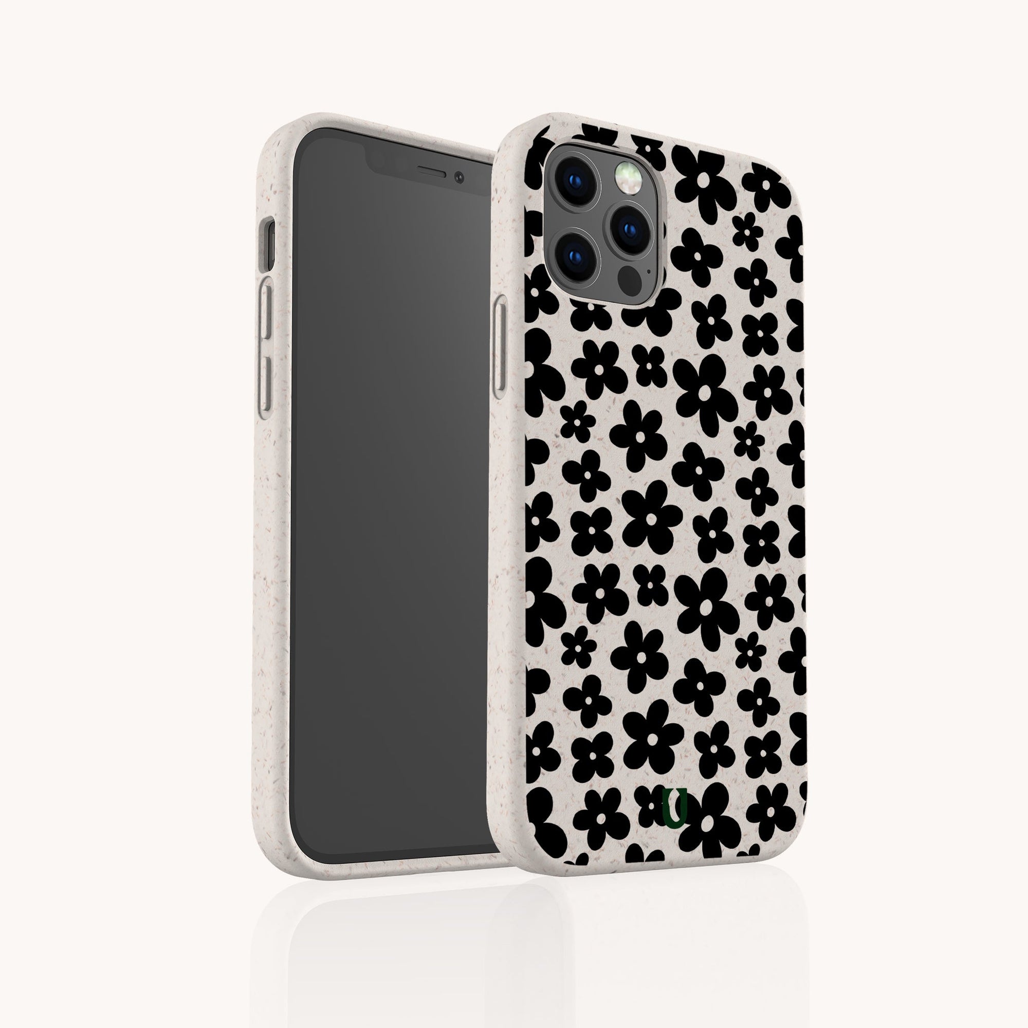 A white Black Flower Power Eco-Friendly Phone Case, featuring a black floral pattern of small, simple flowers, is shown on a smartphone angled to display both its back and screen against a plain white background.