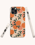 The Orange Blossom Eco-Friendly Phone Case features a compostable design with illustrated oranges, green leaves, and white flowers on a beige background. The image displays the case’s eco-friendly materials from the back and both sides.