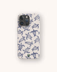 The Turtles Eco-Friendly Phone Case features a blue and white hand-drawn sea turtle pattern on a light background and is made from sustainable materials.