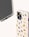 Two smartphones in beige Mini Confetti Eco-Friendly Phone Cases are shown; one shows the screen, the other features a colorful terrazzo pattern. These compostable cases fit iPhone and Samsung Galaxy models.
