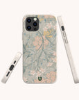 The Jasmine Eco-Friendly Phone Case, made from zero-waste materials, displays pastel floral motifs with delicate pink flowers and green leaves. It is shown from three angles against a plain light background.