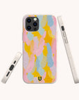 The Bubble Gum Eco-Friendly Phone Case features a pastel abstract pattern with vibrant pink, yellow, blue, and beige brushstrokes, displayed from the back, side, and front on a plain white background.