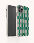 The Green Watercolour Checker Eco-Friendly Phone Case, made from biodegradable materials, features a green checkered design and protects your iPhone or Samsung Galaxy while displayed upright on a white background.