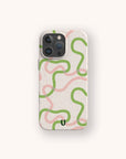 The Green and Pink Swirl Lines Eco-Friendly Phone Case, shown in beige with wavy green and pink lines and a small black U-shaped mark near the bottom, is displayed on a light background. This sustainable phone case is compatible with both iPhone and Samsung Galaxy models.