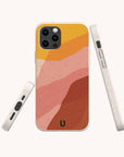 The Cliffs Eco-Friendly Phone Case features a soft, textured finish with abstract wavy stripes in yellow, orange, peach, and rust tones. Compatible with both iPhone and Samsung Galaxy models, this sustainable case is shown from the back, side, and bottom against a white background.