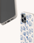 Two beige, speckled phone cases are shown on a light background; one is the Sea Shells Eco-Friendly Phone Case with a blue seashell design. Both offer sustainable craftsmanship and fit iPhone and Samsung Galaxy models.