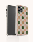 The Pink and Green Checker Eco-Friendly Phone Case, shown in speckled white with a pink, green, beige, and white checkerboard back, fits iPhone and Samsung Galaxy; images display both the patterned back and phone screen.