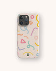 The Confetti Eco-Friendly Phone Case features colorful abstract shapes and squiggles in pink, yellow, blue, orange, and green on beige, with a black "U" logo. Compatible with iPhone and Samsung Galaxy models.