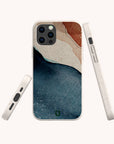 The Watercolour Landscape Eco-Friendly Phone Case features an abstract navy blue, beige, and rust design. It is compostable and is shown from the back, side, and bottom angles on a light background.