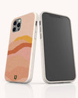 Two smartphones in light beige speckled Hills Eco-Friendly Phone Cases; one displays the screen, while the other showcases a case design featuring abstract wavy lines in pink, orange, and peach tones. A small green horseshoe logo at the bottom highlights its eco-friendly construction.