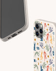 Two smartphones with light-colored cases. One showcases the Joie de Vivre Eco-Friendly Phone Case, decorated with colorful abstract shapes, eyes, hands, and figures in an artistic style, while the other case is plain and leaves the phone’s screen and charging port visible.