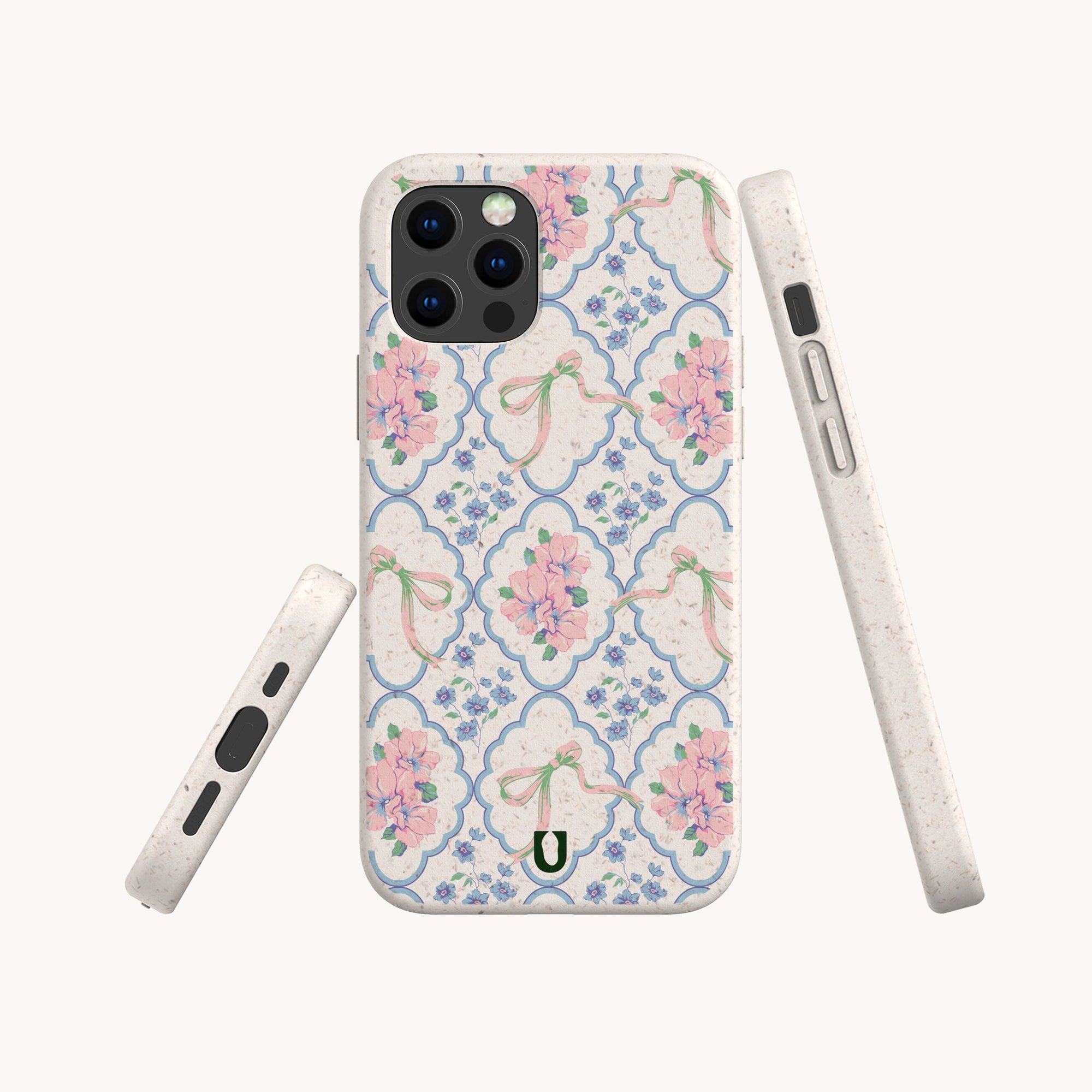 The Pink Ribbons Eco-Friendly Biodegradable Phone Case features a pastel floral pattern with pink flowers and green bows on a white background, shown from various angles on a plain, light backdrop.