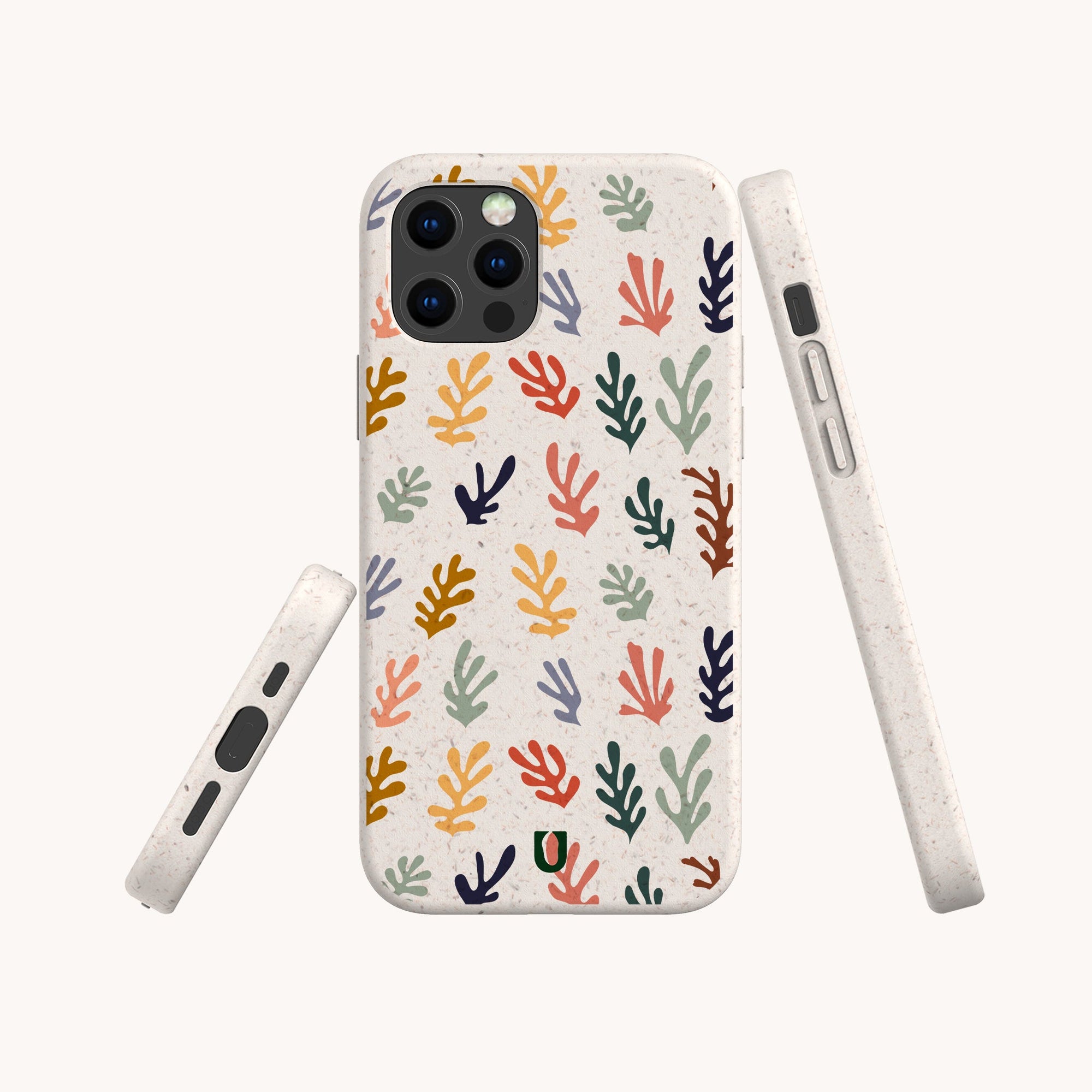 The Algae Eco-Friendly Phone Case features a vibrant abstract leaf or coral pattern in yellow, orange, red, purple, and green on a light speckled background. Made from biodegradable materials and displayed from several angles.