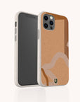 Two smartphones in beige cases, one facing forward to showcase the screen and the other backward displaying the Terracotta Abstract Strokes Eco-Friendly Biodegradable Phone Case—a tan and white abstract wavy design with a small green logo at the bottom. These cases offer stylish protection while supporting sustainability.