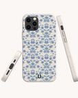 The Blue Ditsy Flowers Eco-Friendly Biodegradable Phone Case is displayed from three perspectives—front, side, and bottom—showcasing its slim profile, precise button cutouts, and sustainable materials. Featuring a white base adorned with a delicate blue and purple floral pattern, this case offers stylish protection for your device while minimizing environmental impact.