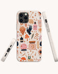 Introducing the Love Spell Eco-Friendly Phone Case—a biodegradable phone case designed for zero-waste living and magical style. Whimsical patterns of mushrooms, potion bottles, candles, stars, hands, and mystical symbols in orange, pink, and navy adorn its cream background. Four product views highlight the sides and back design for a complete look at this enchanting accessory.