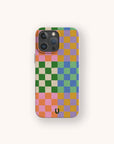 The Colour Checker Eco-Friendly Phone Case features pink, orange, green, blue, and purple squares with a small black horseshoe near the bottom center. Stylish iPhone compatible protection.