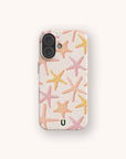 A smartphone with the Starfish Eco-Friendly Biodegradable Phone Case in light beige, adorned with pink, orange, and yellow starfish patterns. This biodegradable case features a small green horseshoe symbol at the bottom center.