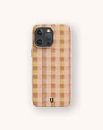 The Pink Watercolour Gingham Eco-Friendly Phone Case features a pink gingham pattern with a small black horseshoe near the bottom center, displayed against a plain light background.