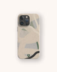 A smartphone with the Green Abstract Lines Eco-Friendly Phone Case in beige, showcasing abstract green, gray, and black curves on a light background. The phone is centered on an off-white backdrop.
