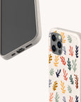 Two smartphones in beige: one with the Algae Eco-Friendly Phone Case, showcasing a colorful coral pattern made from biodegradable materials, and the other with a plain case displaying the phone’s front and bottom edge.