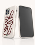 Two smartphones in speckled off-white Brown Bow Ribbon Eco-Friendly Phone Cases are shown—one displays the screen, the other reveals a brown bow ribbon design with sustainable features and a small green loop at the bottom.