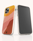 Two smartphones featuring Cliffs Eco-Friendly Phone Cases in white speckled designs: the back case showcases an abstract pattern in shades of yellow, pink, and orange, while the front displays a blank black screen. These sustainable cases are compatible with both iPhone and Samsung Galaxy models, providing a stylish and eco-conscious choice for your device.