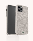 The Terrain Lines Eco-Friendly Phone Case in beige features a compostable design with a dark-lined topographic map pattern, shown on a smartphone from the back and side angles against a plain white background.