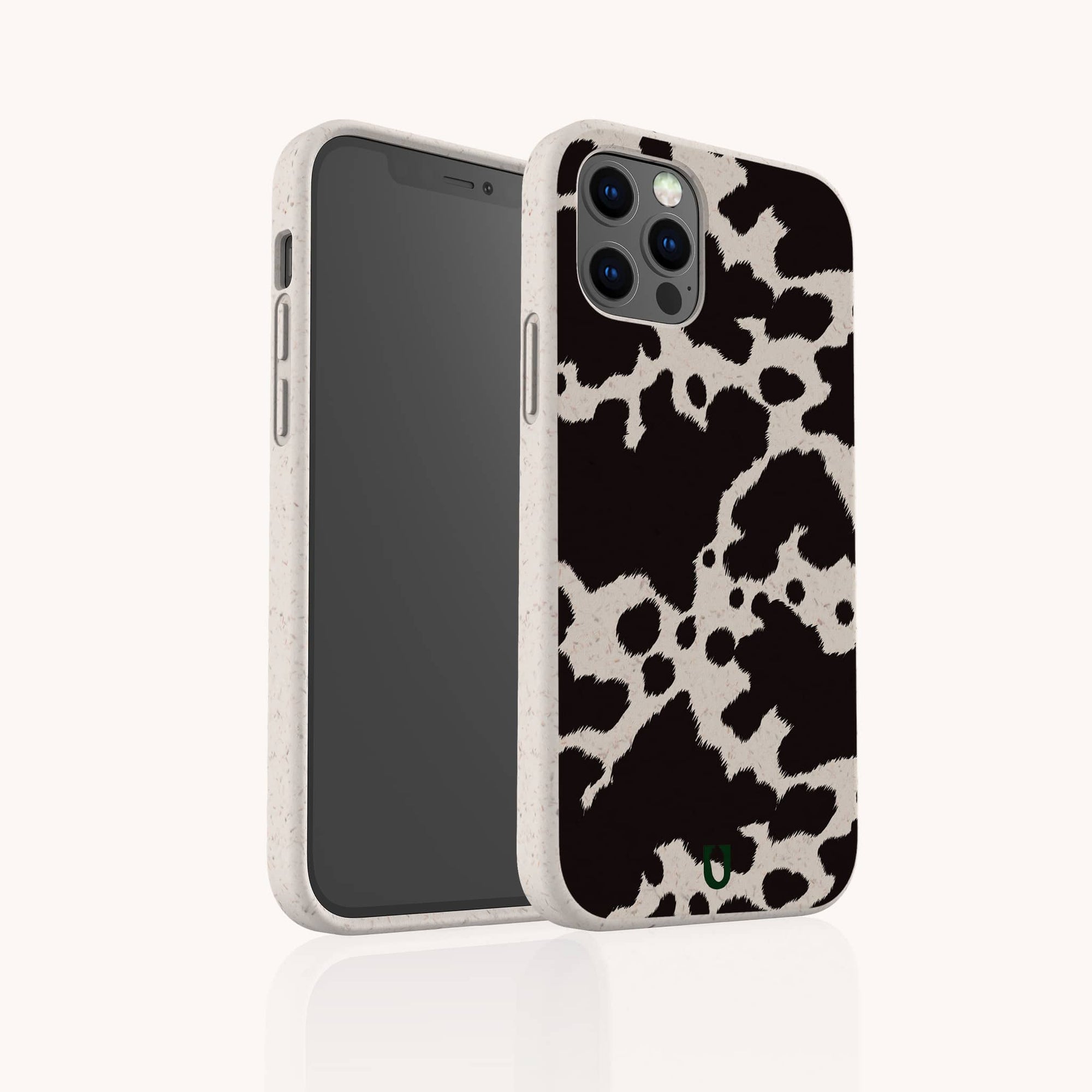 The Cow Print Eco-Friendly Phone Case, shown from front and back on a plain light background, features a speckled white border and full edge coverage. Compatible with iPhone and Samsung Galaxy models.