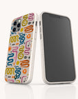 Two smartphones with white cases stand upright on a white reflective surface. One features the Year Of The Snake Eco-Friendly Biodegradable Phone Case, adorned with a colorful abstract pattern of squiggles, eyes, and stars inspired by the Year of the Snake collection. The other phone displays a blank black screen. Both sustainable phone cases emphasize eco-friendly design.