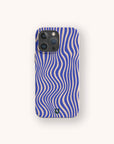 A Cobalt Distort Lines Eco-Friendly Phone Case, adorned with wavy blue and beige lines in an optical illusion pattern, is showcased on a smartphone against a plain light background.